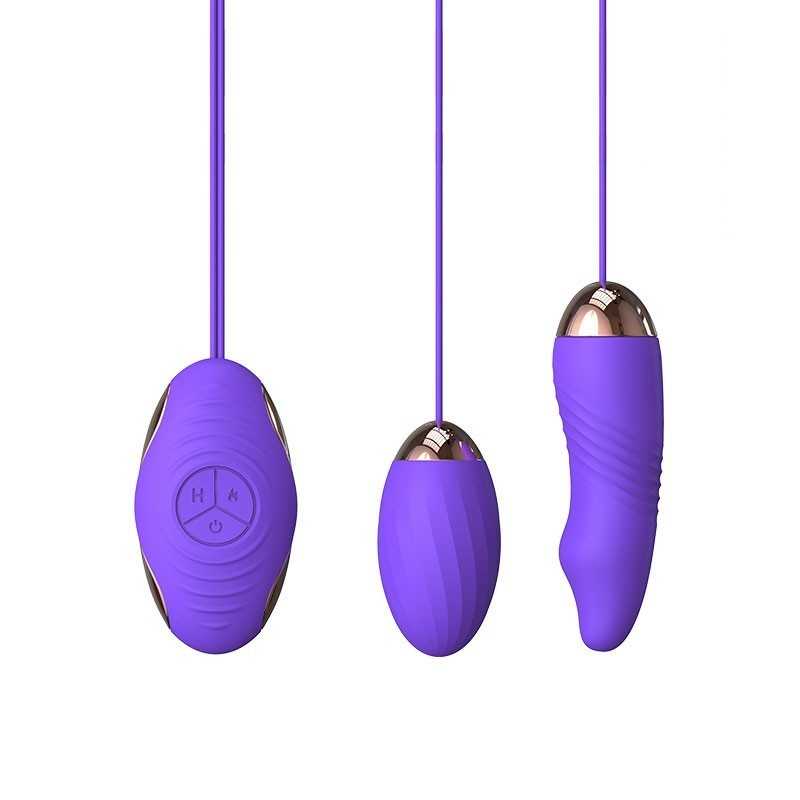 Overhead flat-lay photograph of three purple personal massager devices with cords arranged on a white background, soft studio lighting, neutral mood